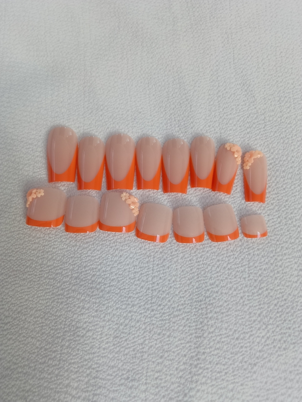 Nude Press-On Nails with Bright Orange French Tips and Sequin Accent